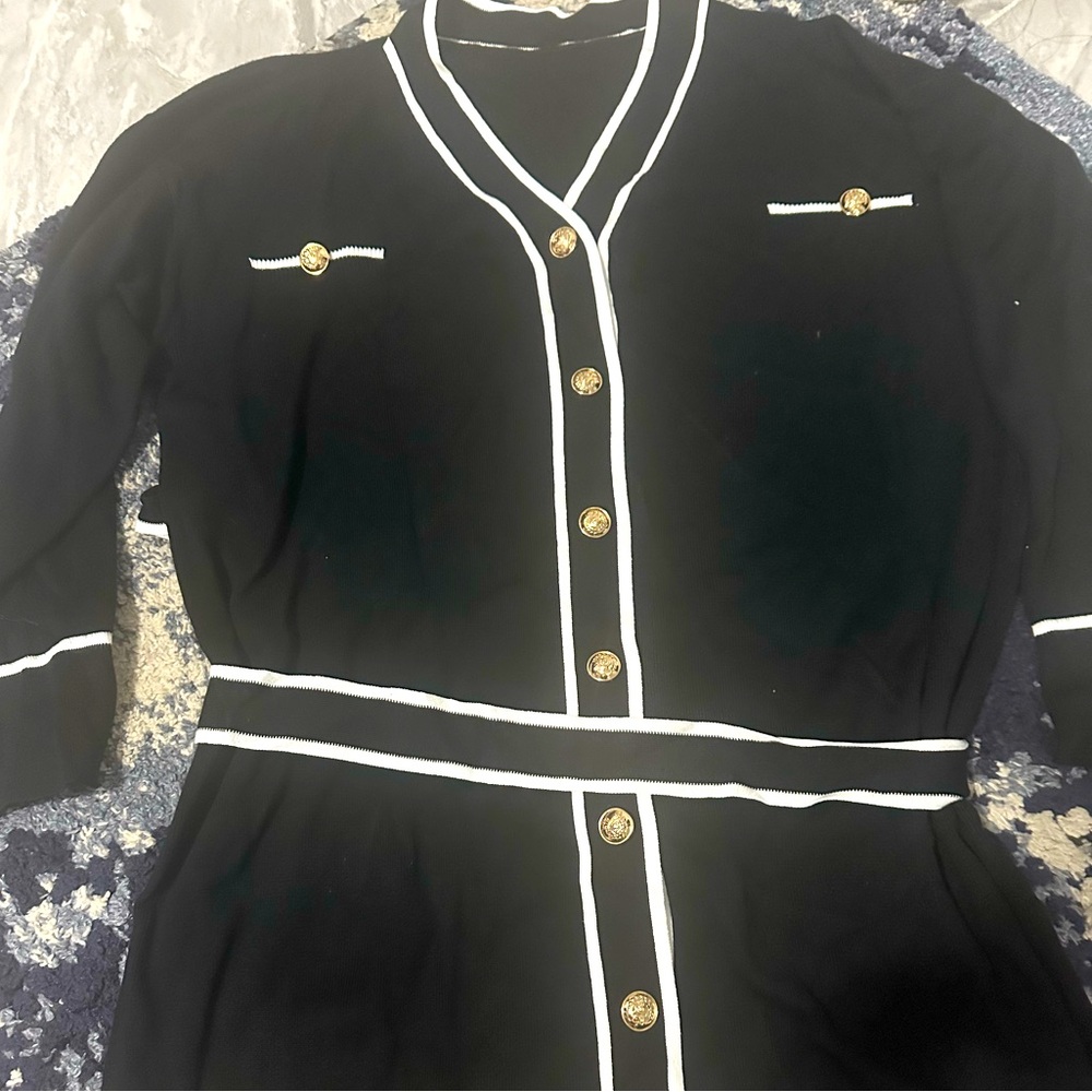 Black and sweater with gold buttons and tie around waist